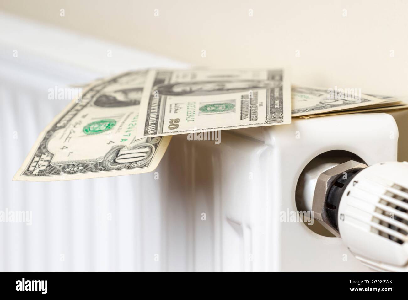 Expensive heating costs. Paying bills. US dollars banknotes on heating