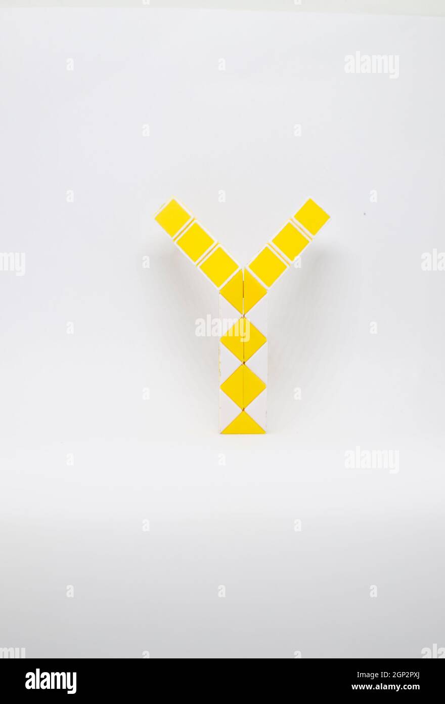 Letter 'y' made of yellow and white triangles on a white background. Stock Photo