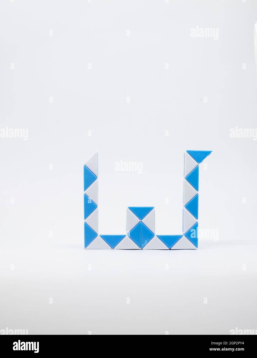 Letter 'w' made of blue and white triangles on a white background. Stock Photo