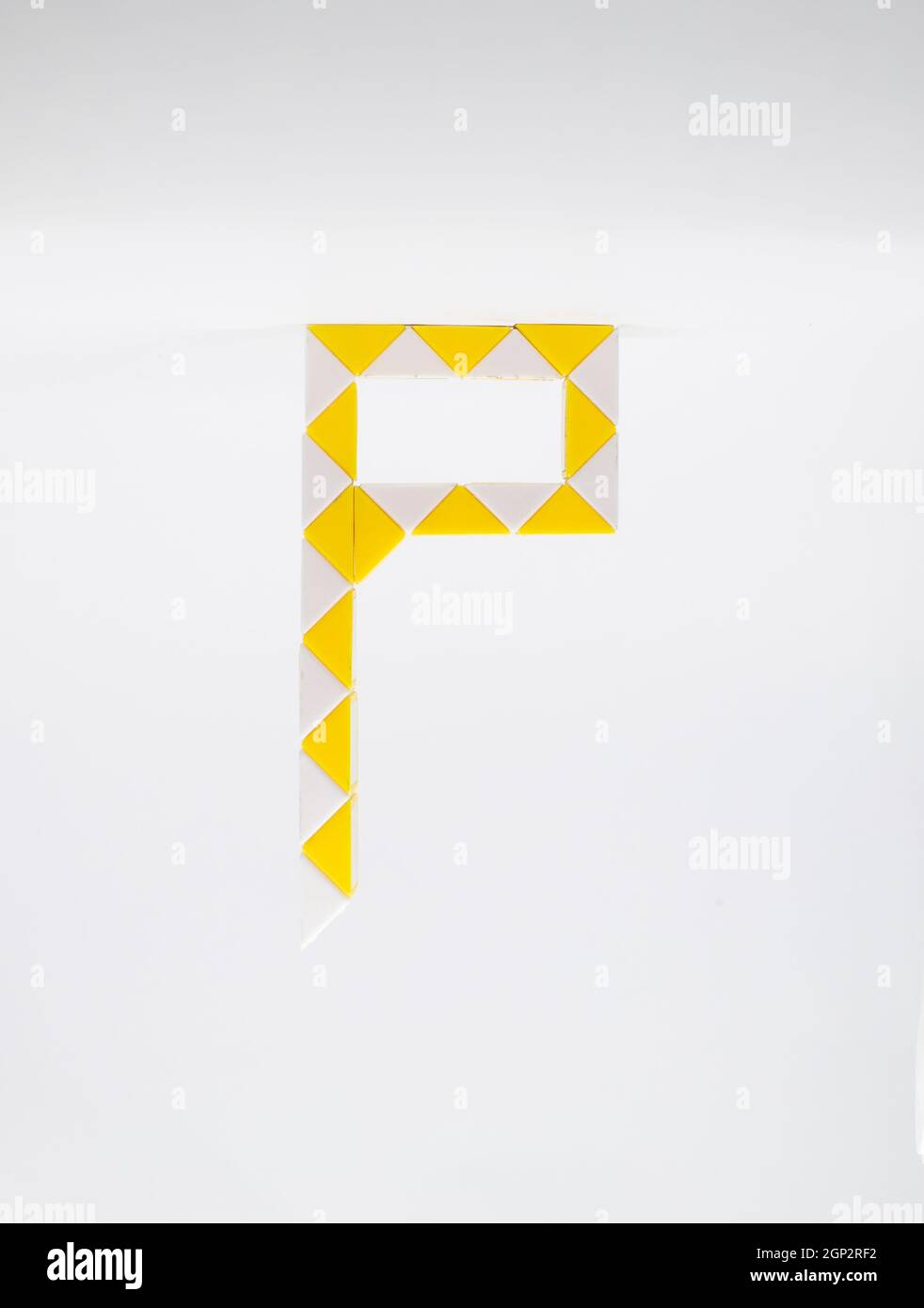 Letter 'p' made of yellow and white triangles on a white background. Stock Photo