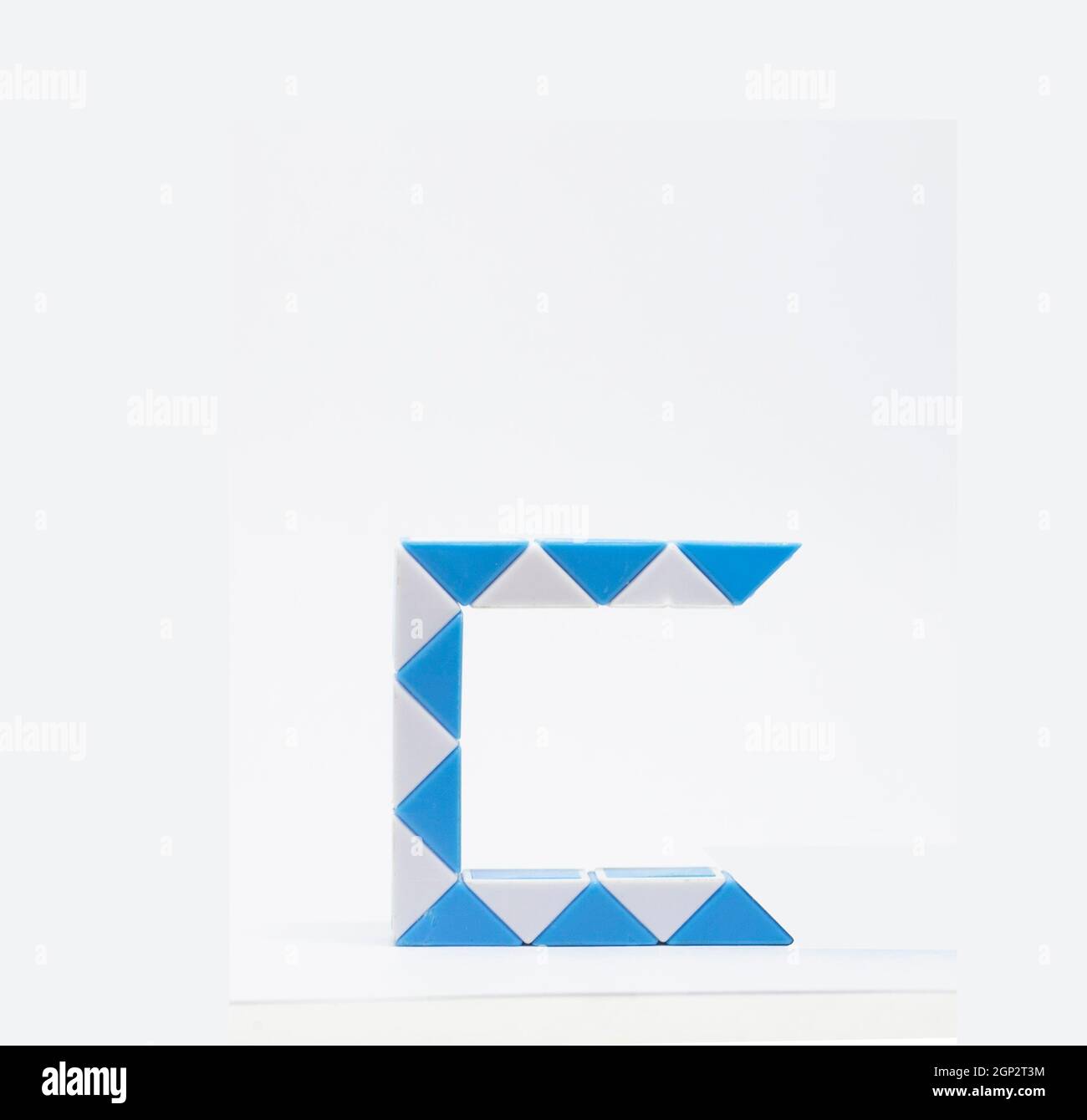 Letter 'c' made of blue and white triangles on a white background. Stock Photo