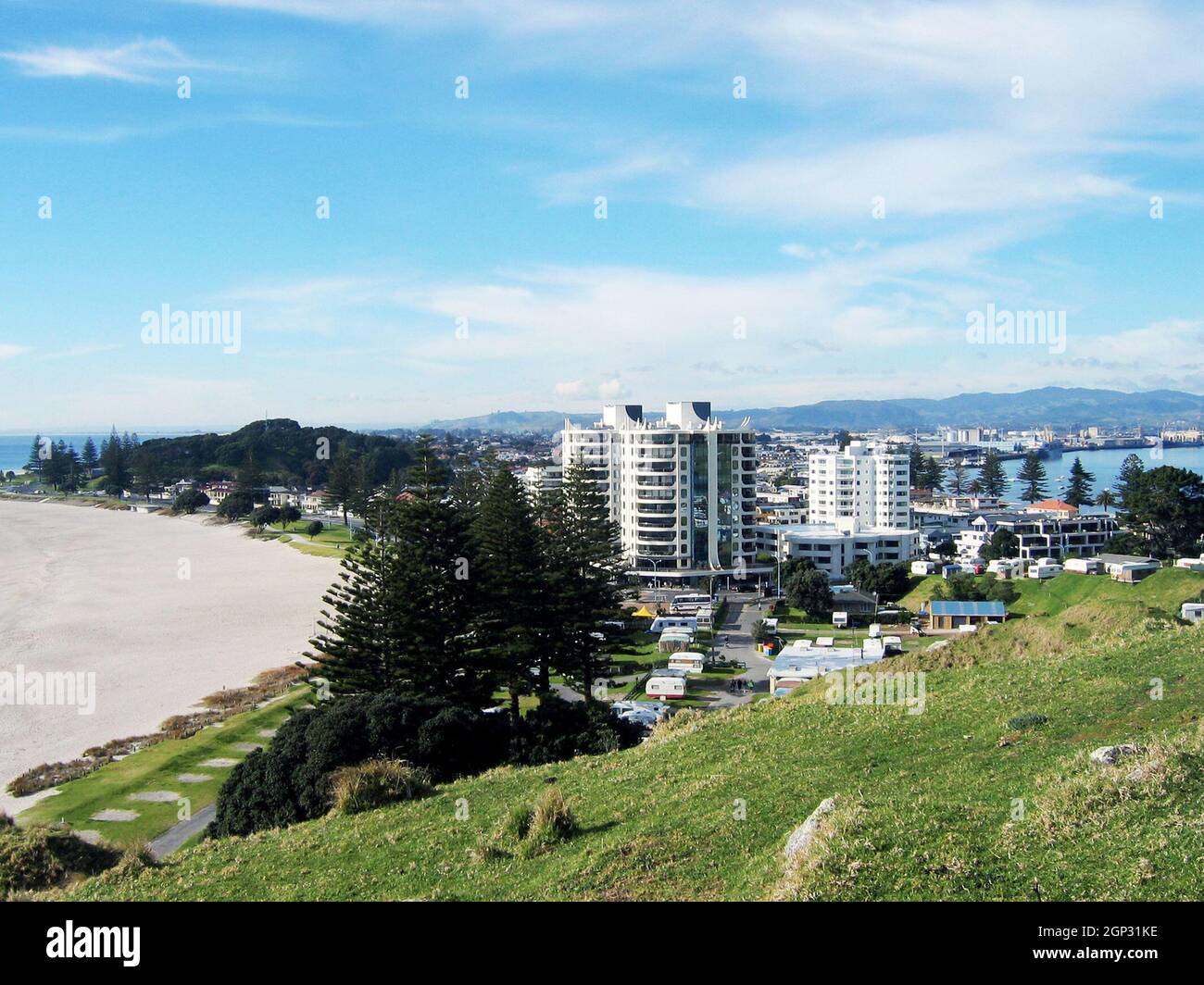 A view of Mt. Maunganui Beach and development along the seashore from atop Mt. Maunagnui, also referred to as Mauao, in the Bay of Plenty of New Zealand.  The Pacific Ocean beach side town is a popular destination especially known for its seascape and landscape. Stock Photo
