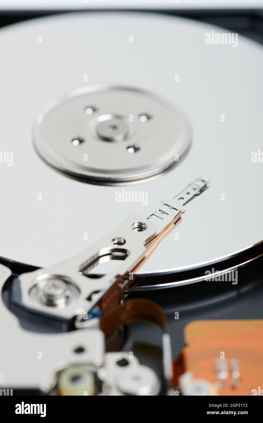 Hard drive metal disk with reader head macro close up view Stock Photo