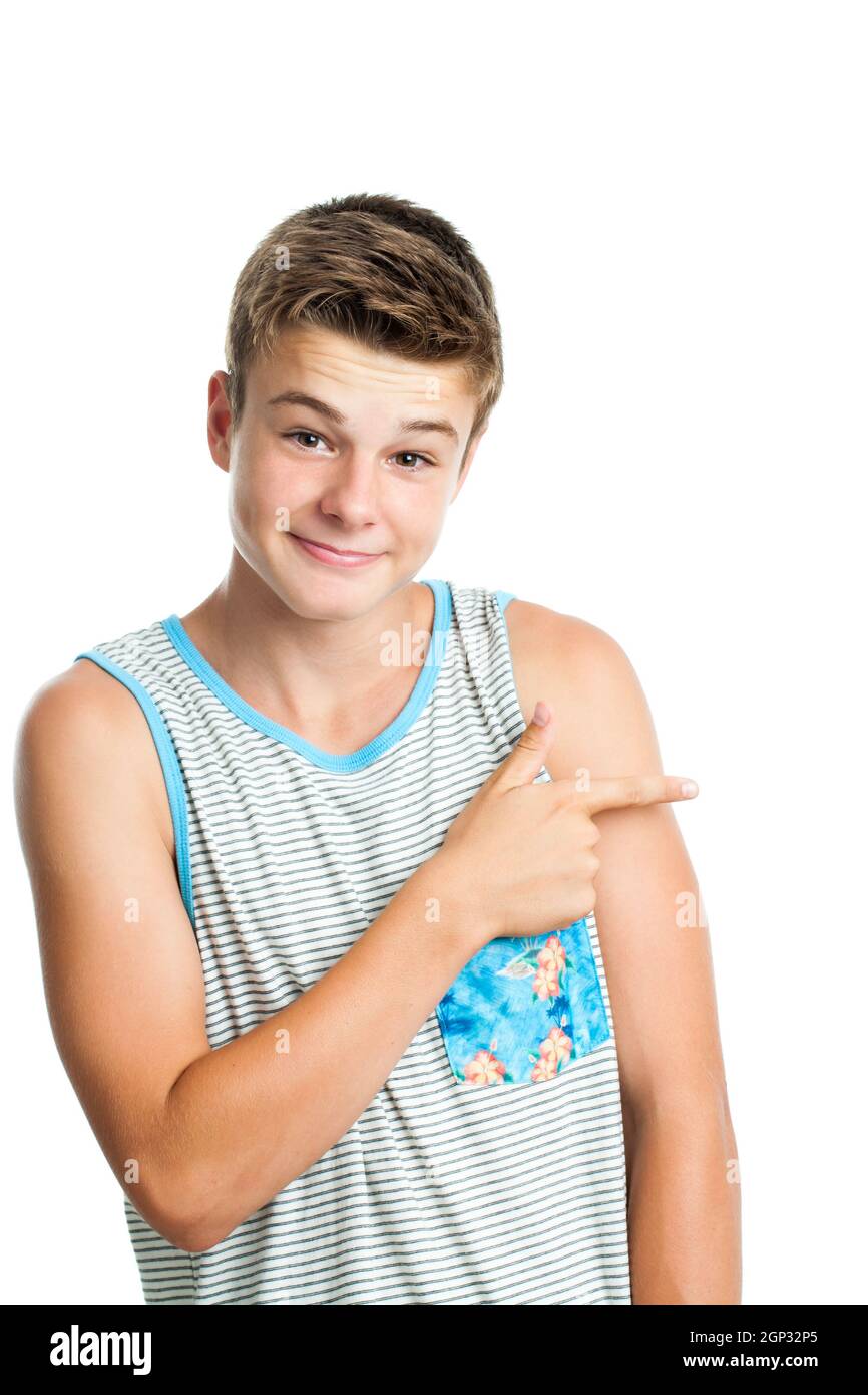 Close up portrait of Attractive teen boy pointing aside with finger.Isolated on white background. Stock Photo