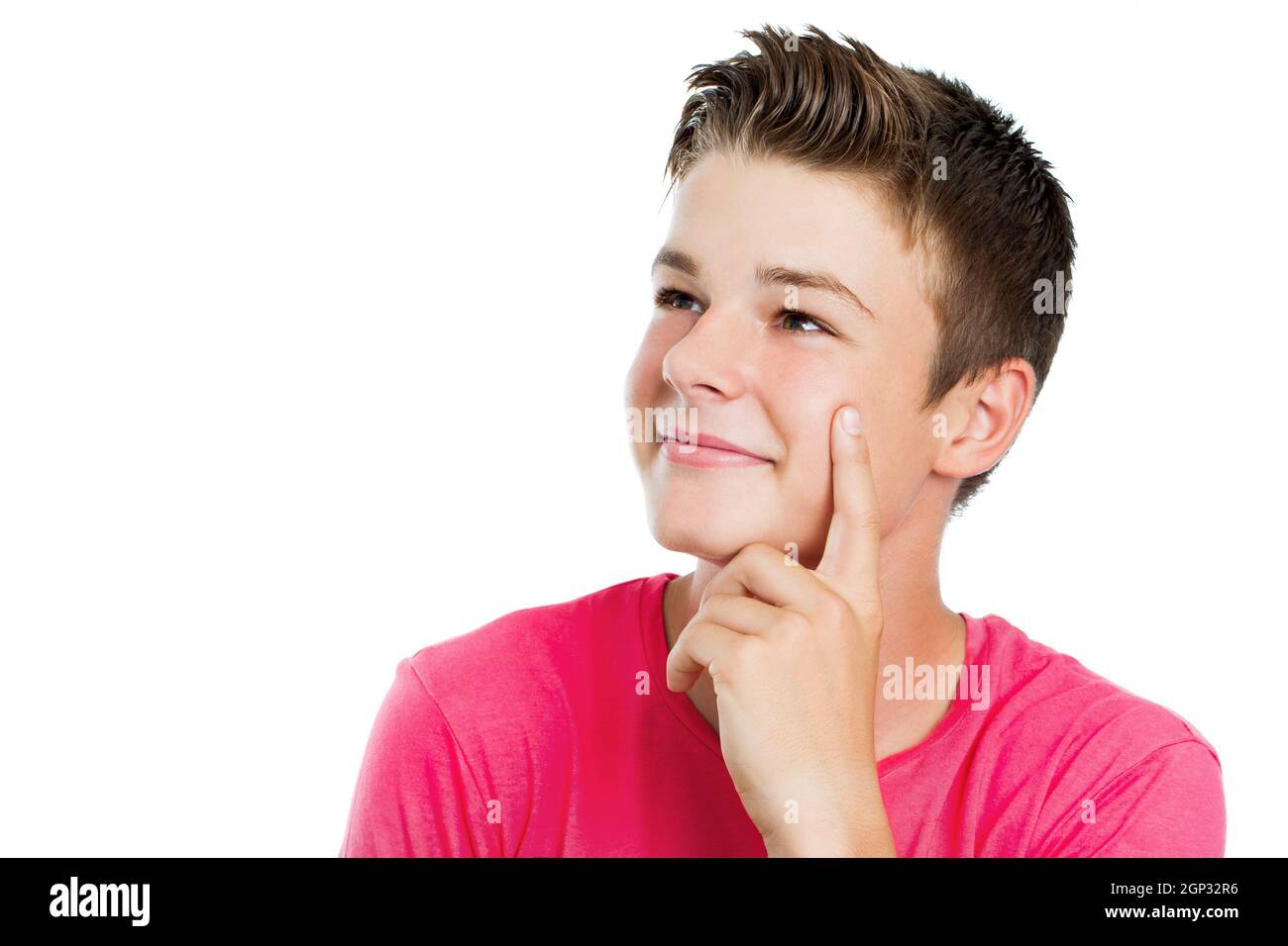Close up portrait of Handsome teen boy wondering and looking aside.Isolated on white. Stock Photo