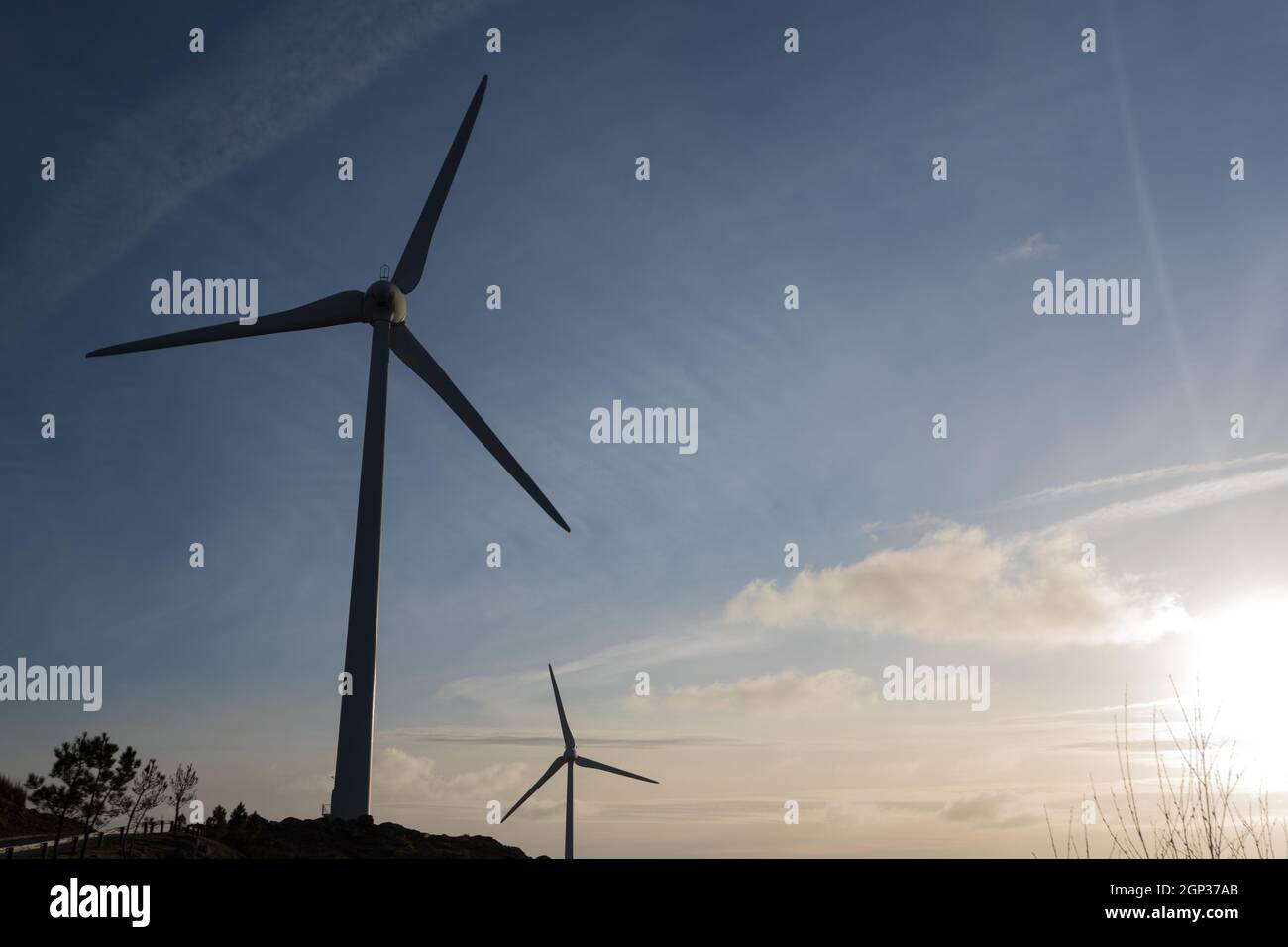 Wind energy turbines, in a landscpae over a beautiful blue sky Stock ...