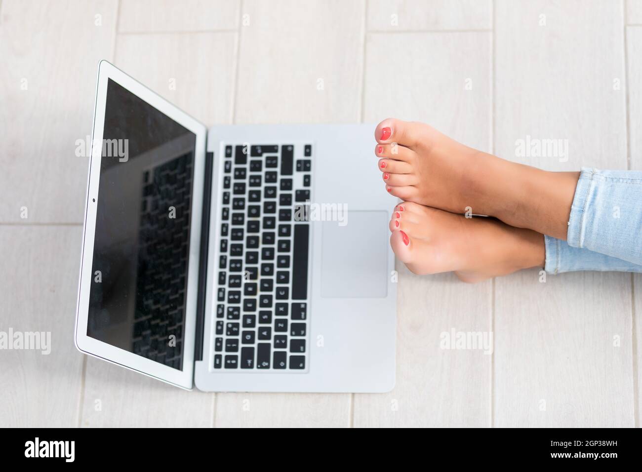Beautiful young woman relaxing at home on her laptop computer Stock ...