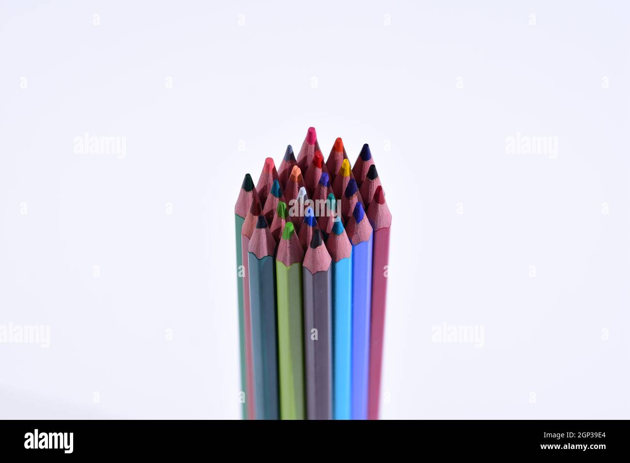 Multi-colored pencils sharpened on a white background, depth of field. Background. Stock Photo