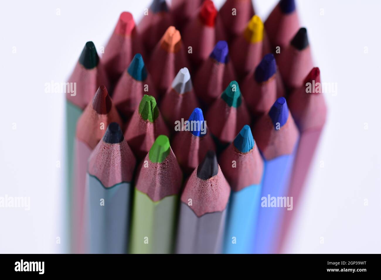 Multi-colored pencils sharpened on a white background, depth of field. Background. Stock Photo