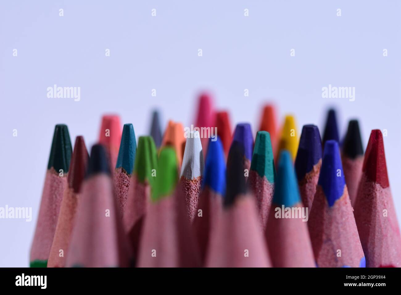 Multi-colored pencils sharpened on a white background, depth of field. Background. Stock Photo