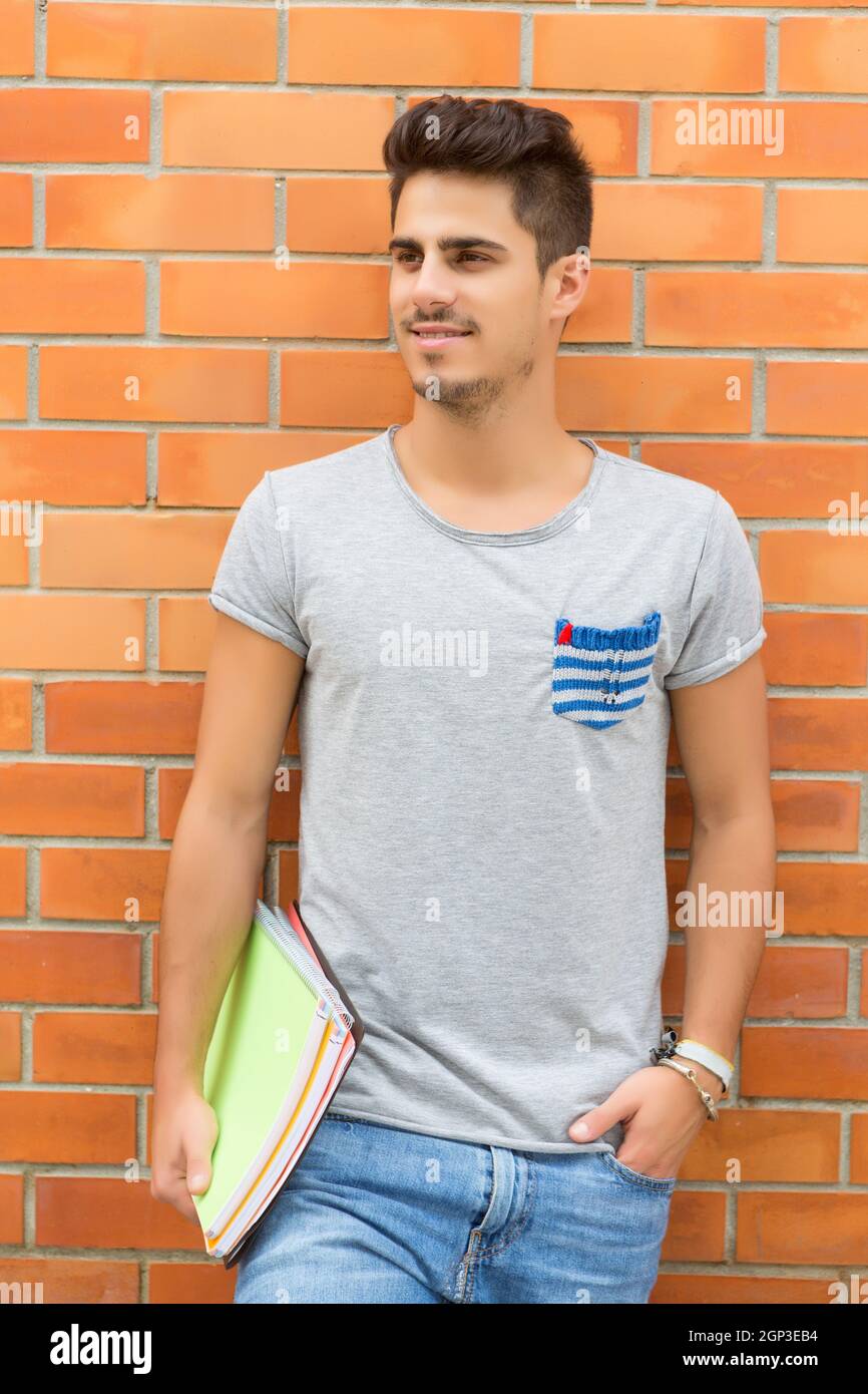 Happy student relaxing at the university campus Stock Photo - Alamy