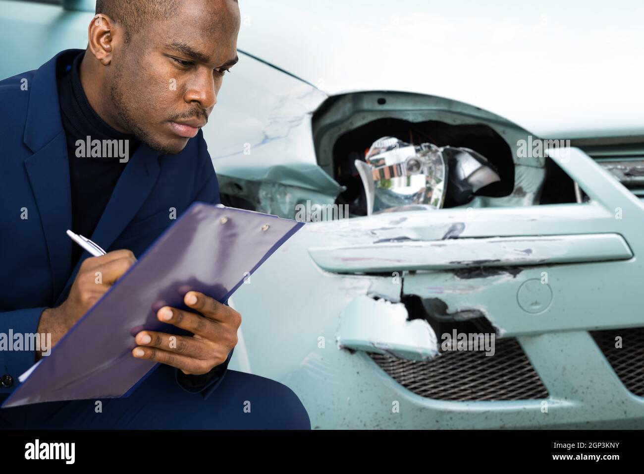 African American Car Insurance Agent Inspecting Accident Claim Stock