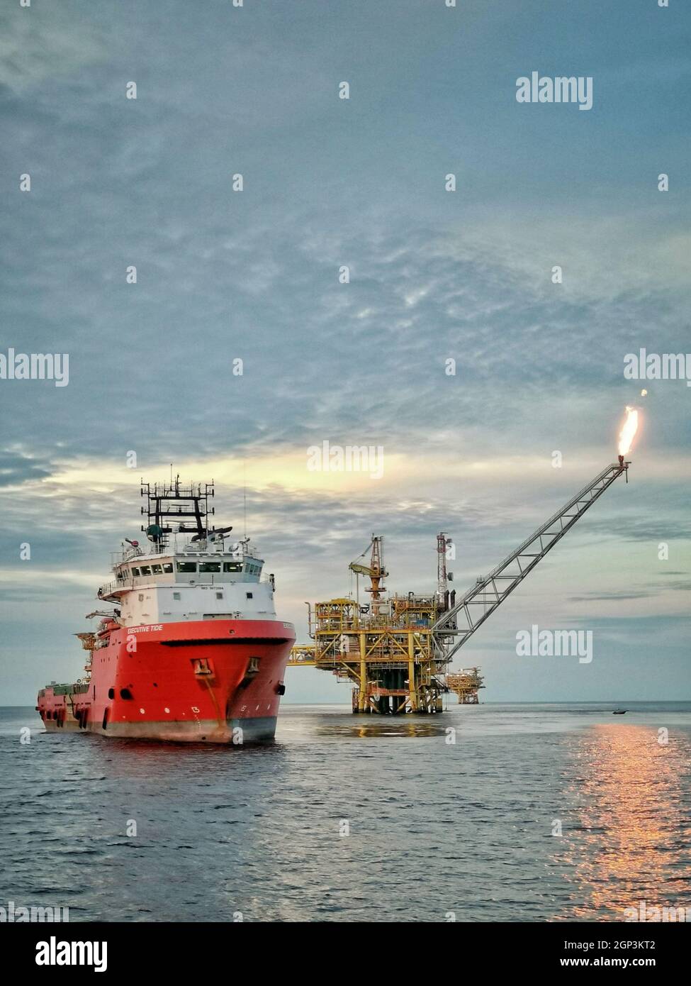 offshore support vessel stand by near oil platform at sea Stock Photo