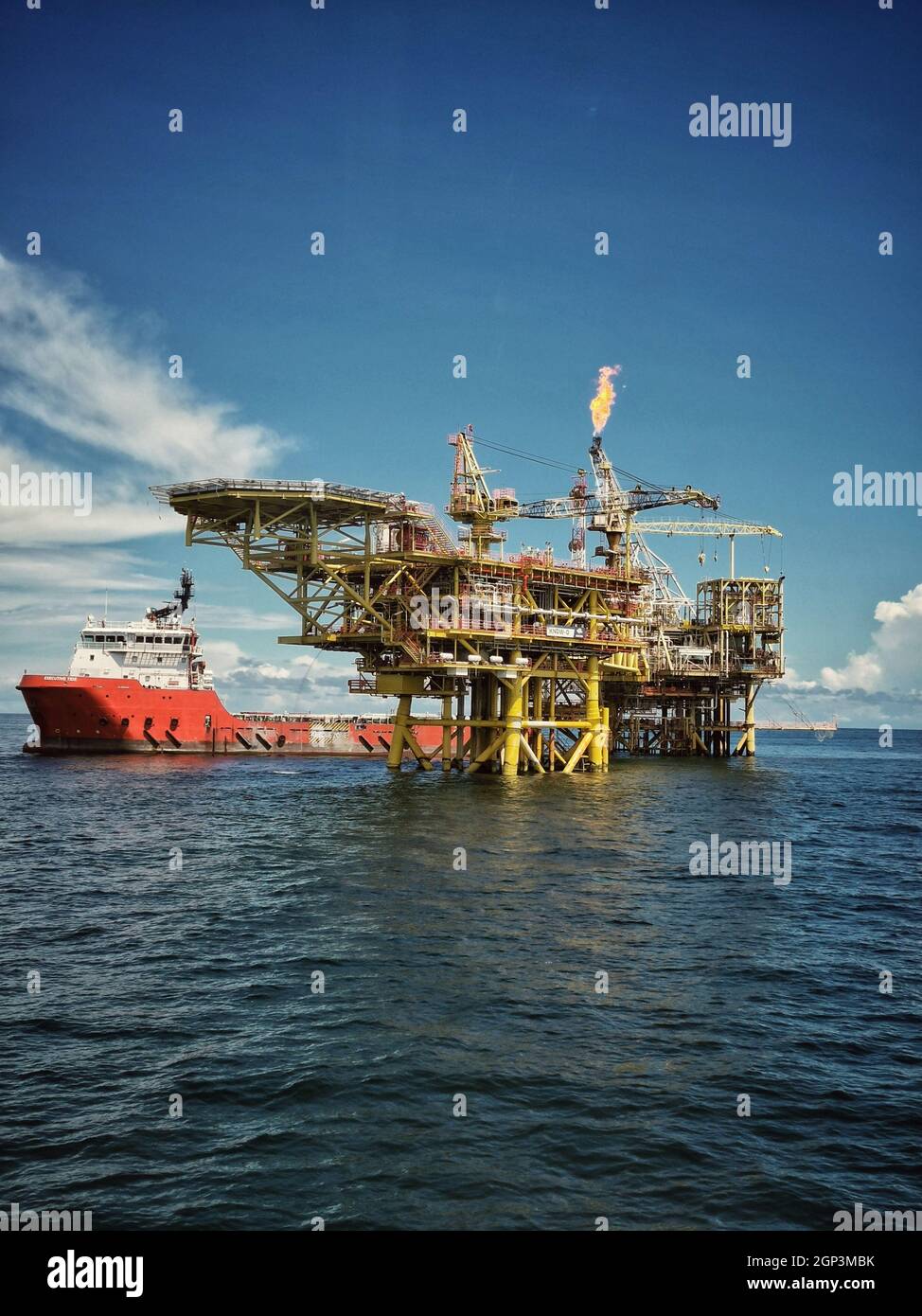 offshore support vessel stand by near oil platform at sea Stock Photo