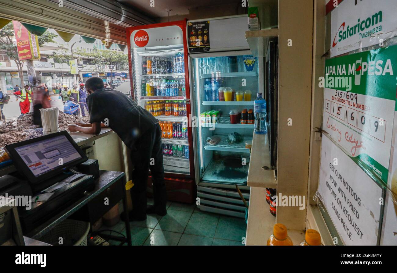 Nairobi, Kenya. 16th Sep, 2021. M-pesa payment information is displayed on the wall of a shop in Nairobi, capital of Kenya, Sept. 16, 2021. TO GO WITH 'Economic Watch: Mobile money innovation a game changer for Africa' Credit: Zhang Yu/Xinhua/Alamy Live News Stock Photo