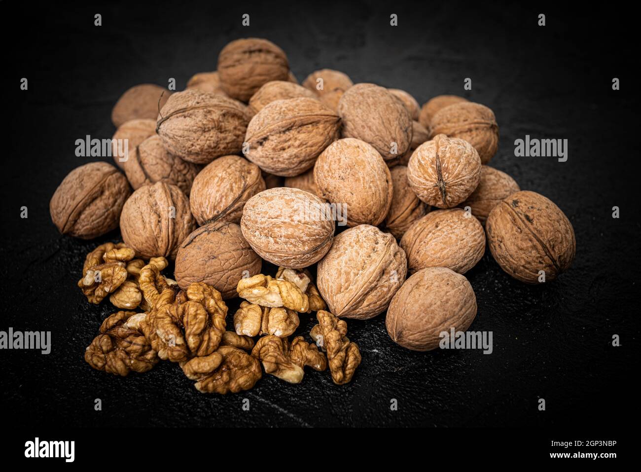 Walnut on over black slate stone background Stock Photo