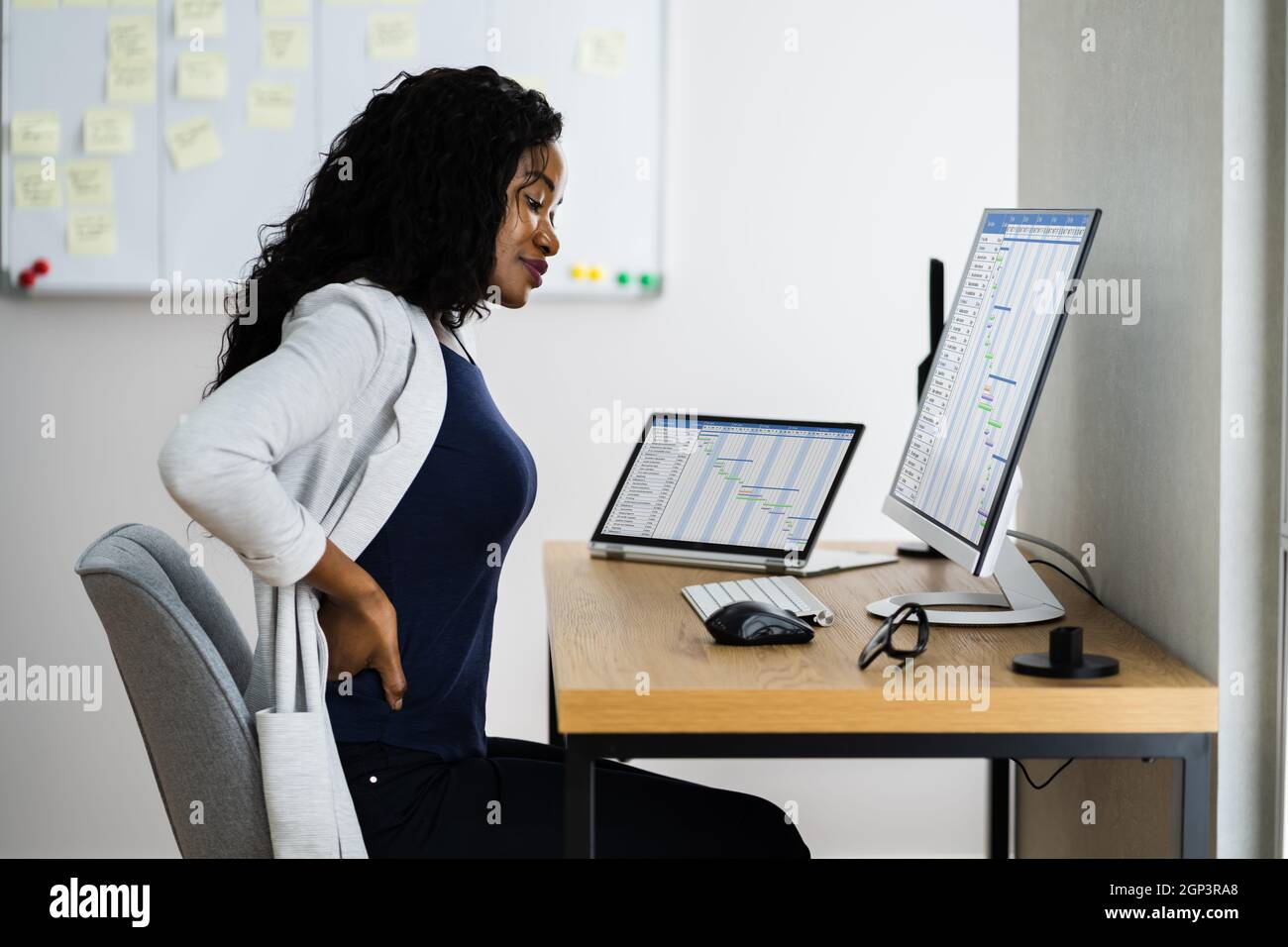 African Back Pain At Work Desk. Posture Problem Stock Photo - Alamy