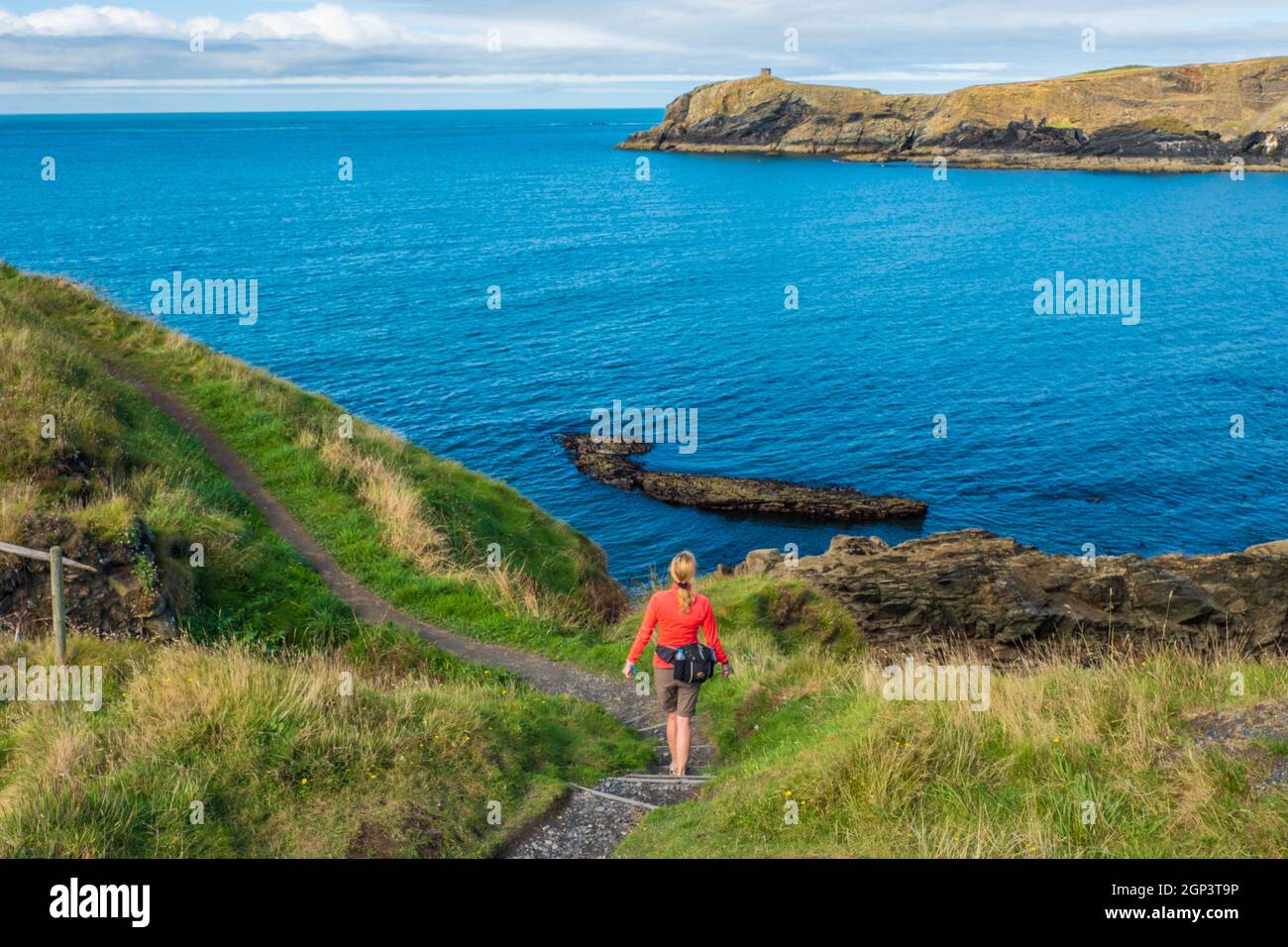 Female walker on a Coastal walk at Abereiddy on the St Davids Peninsula, Pembrokeshire, West Wales. UK Stock Photo