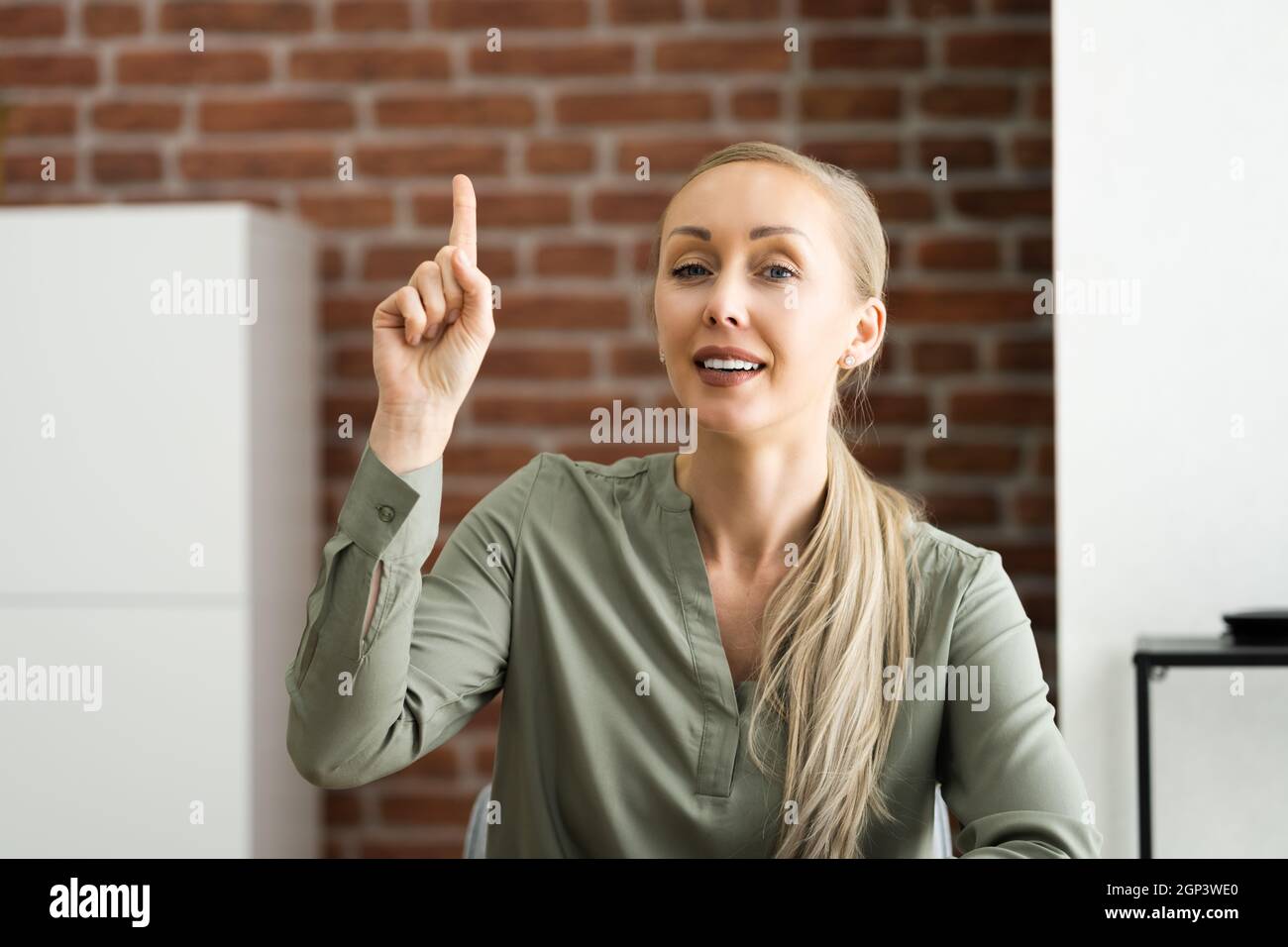 Woman raising hand hi-res stock photography and images - Alamy