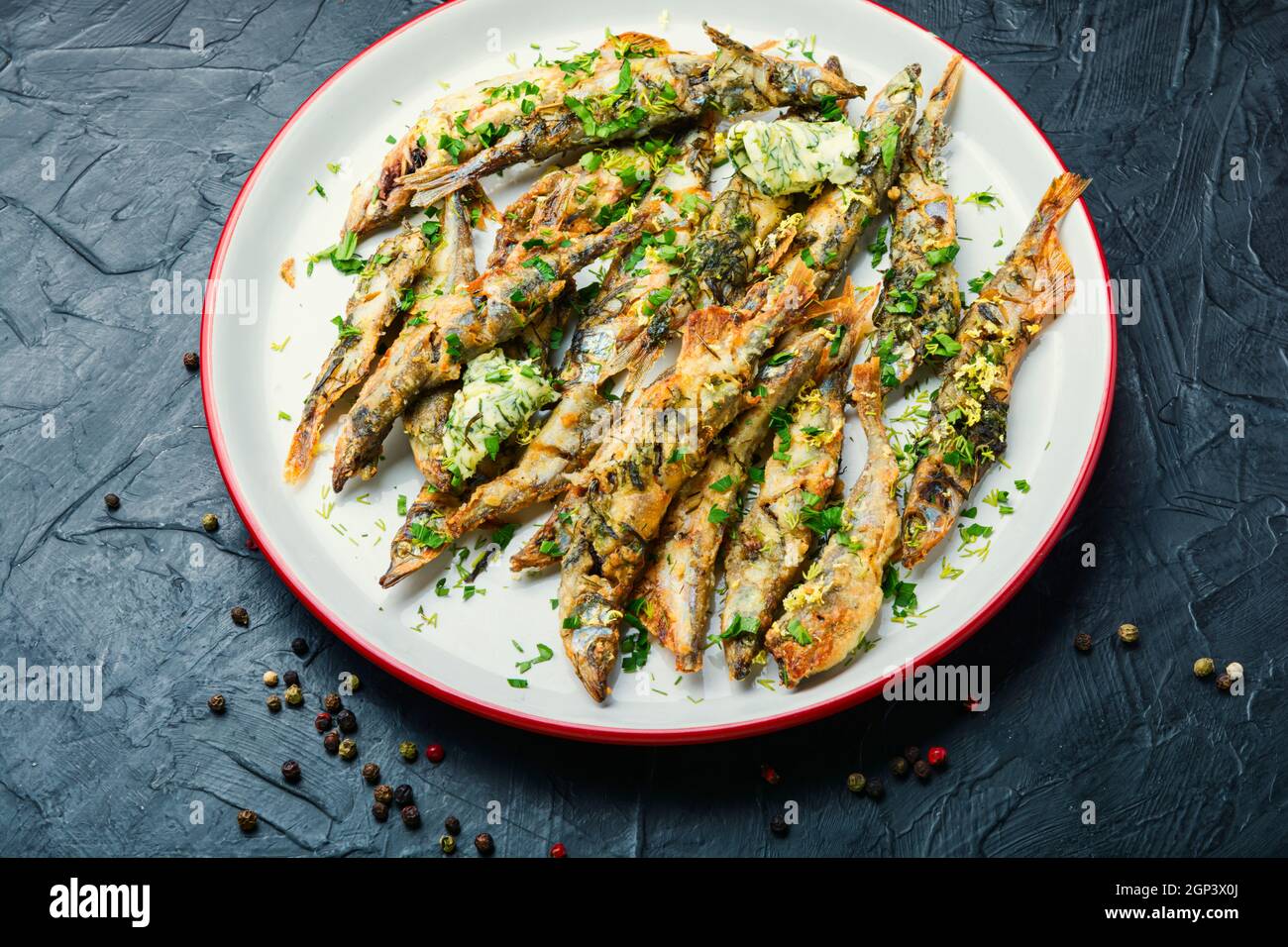 Fried capelin fish with herbs and lemon zest Stock Photo