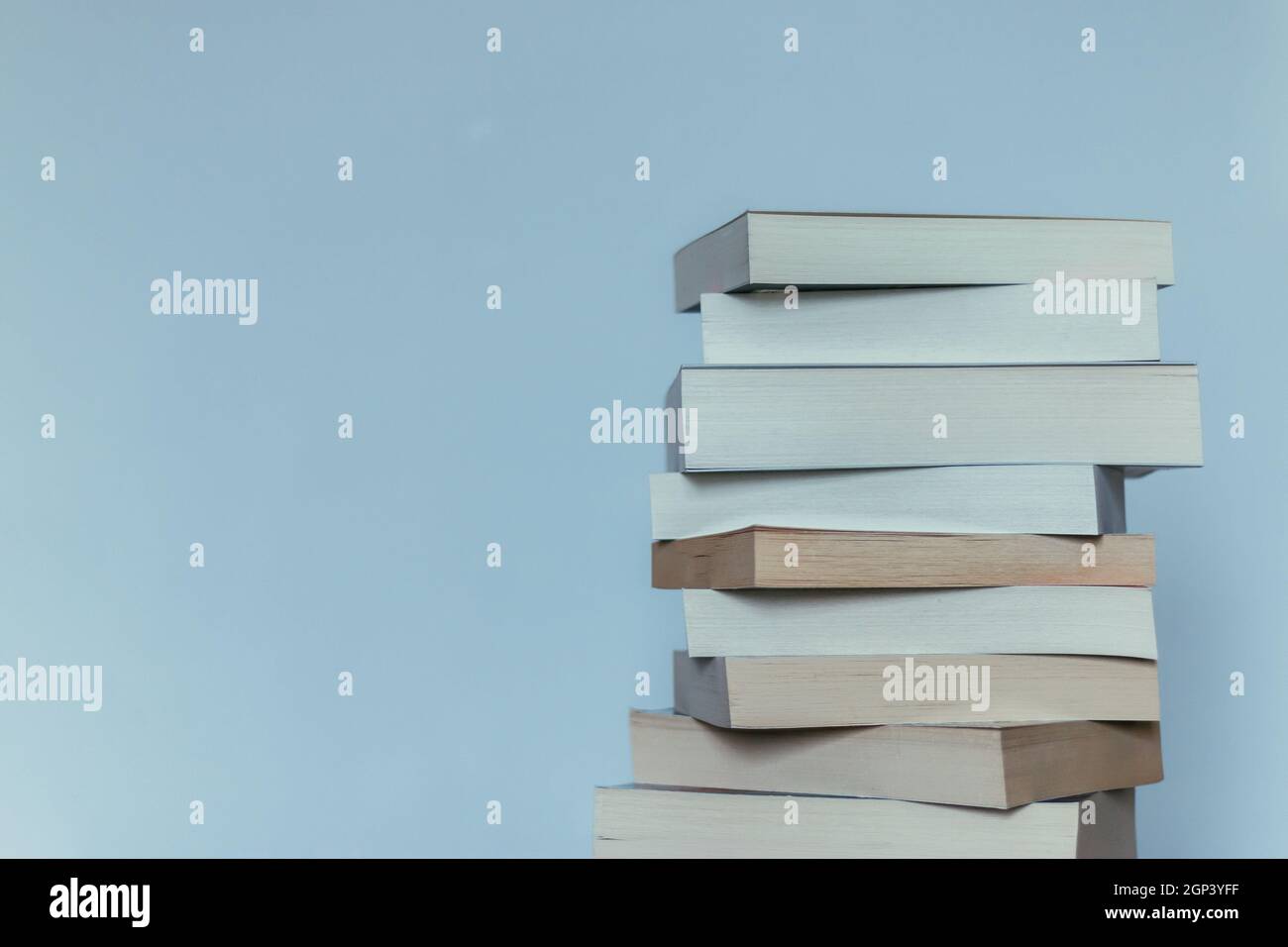 Stack of books before blue background, science concept Stock Photo - Alamy