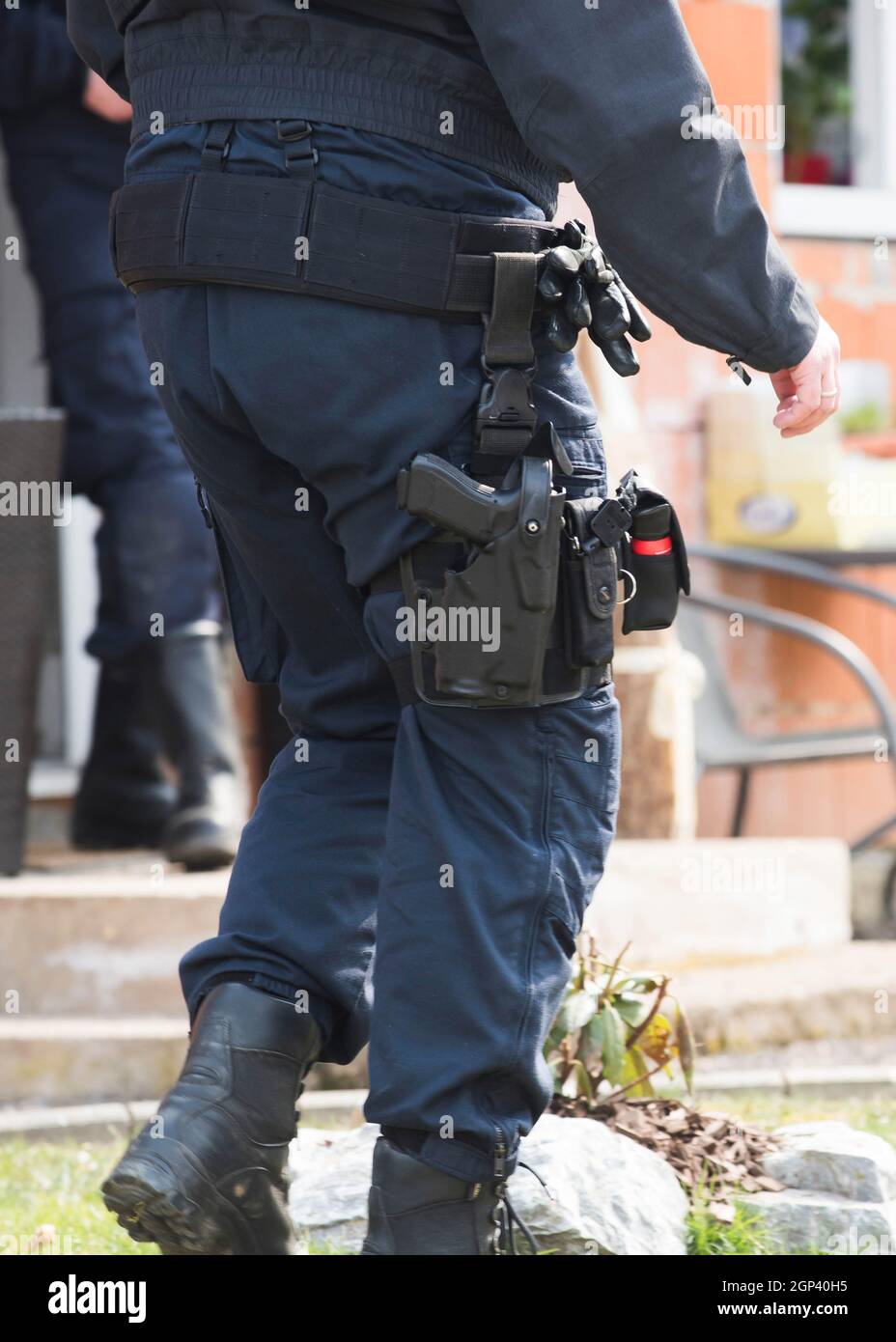 a police officer wearing uniform with his service weapon Stock Photo