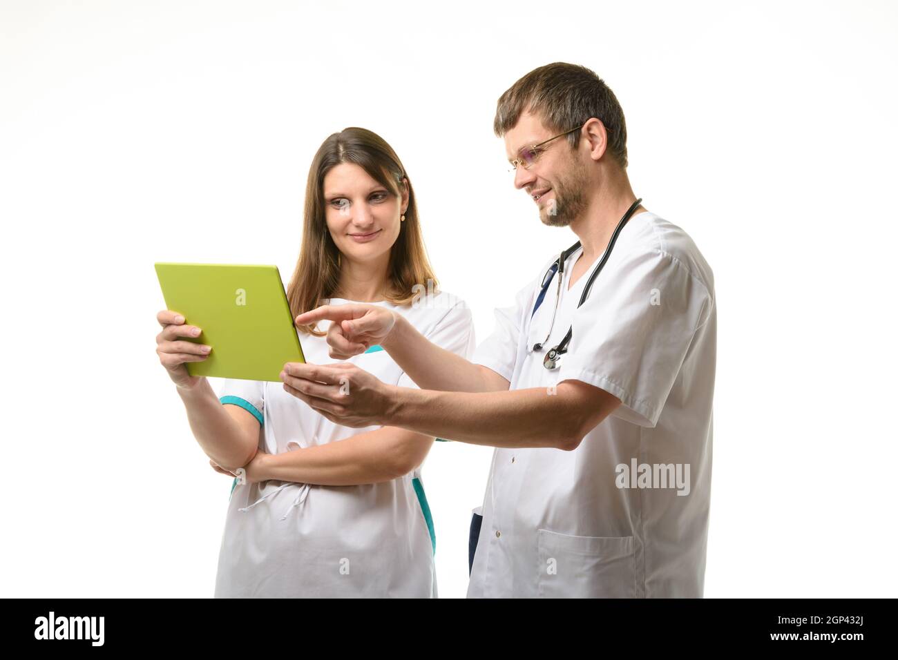 Two doctors discussing the patient's tests while looking at the tablet ...