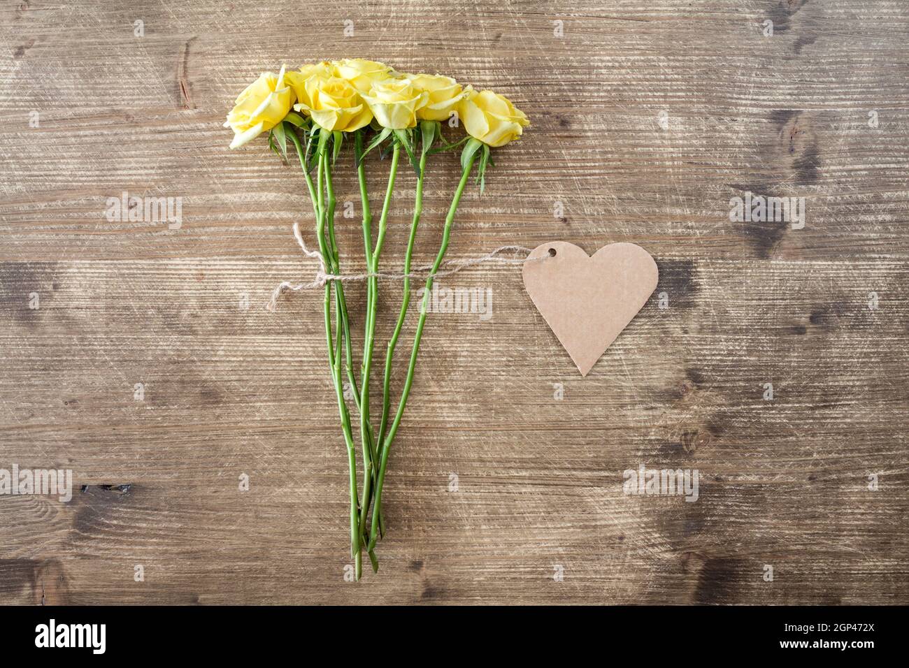 Bunch of yellow roses with heart shaped tag Stock Photo - Alamy