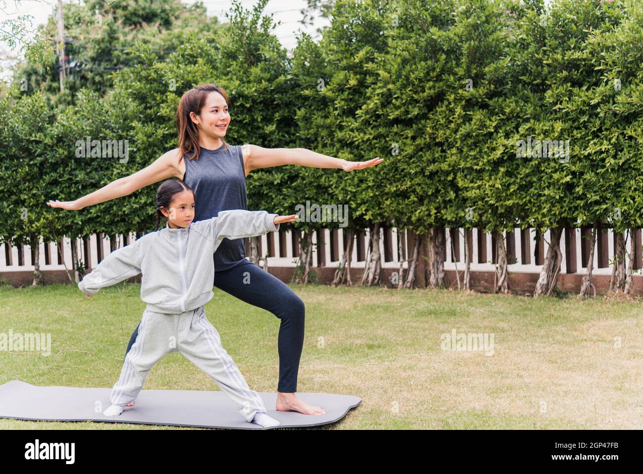 Mother and daughter doing yoga. woman and child training in the park.  outdoor sports. healthy sport lifestyle, chaturanga pose. well being,  mindfulness concept,watching video tutorial online on laptop 8497445 Stock  Photo at