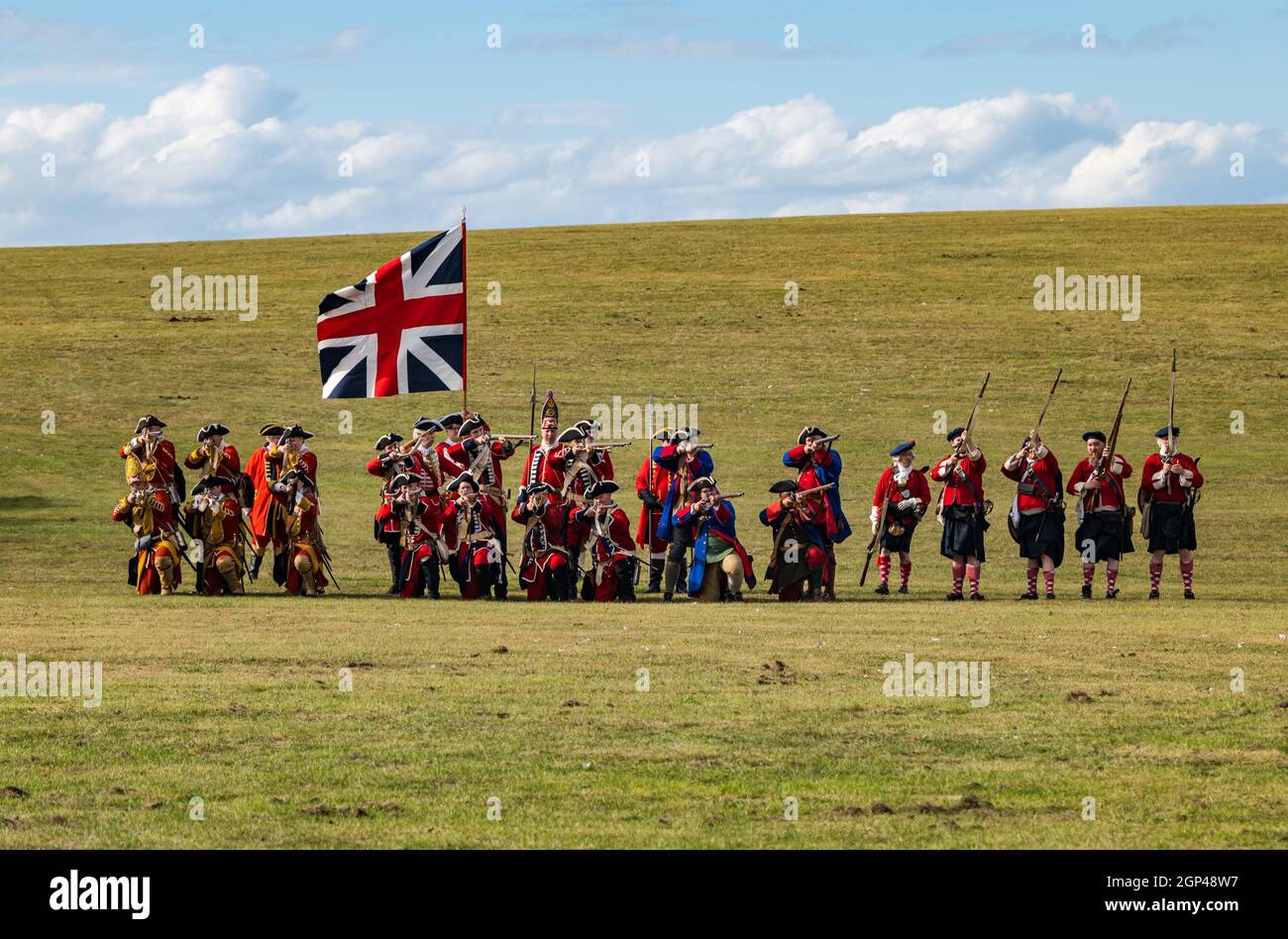 Hanoverian redcoat soldiers in period costume with Union Jack flag in re-enactment of Battle of Prestonpans, East Lothian, Scotland, UK Stock Photo