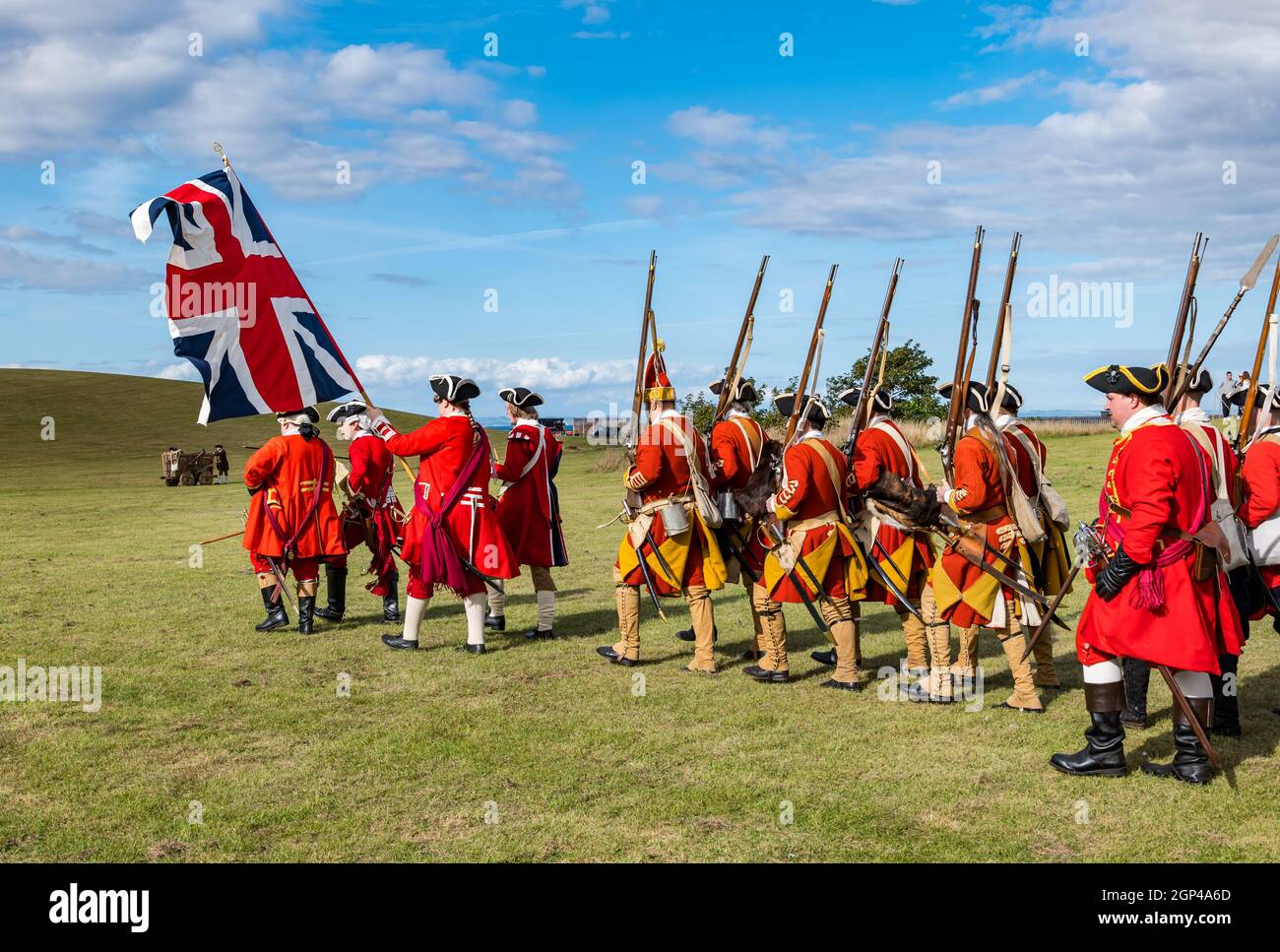 Hanoverian redcoat soldiers in period costume march in re-enactment of Battle of Prestonpans, East Lothian, Scotland, UK Stock Photo