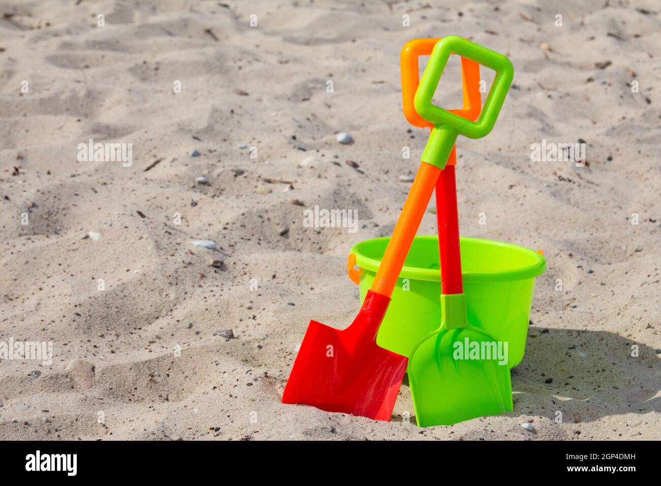 Plastic shovels and bucket on the beach sand Stock Photo Alamy