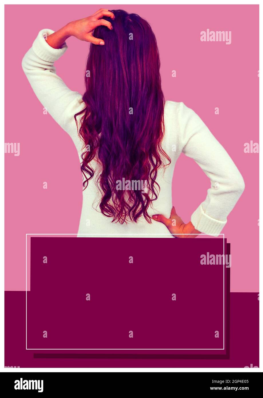 Composition of mixed race woman touching her hair on pink background Stock Photo