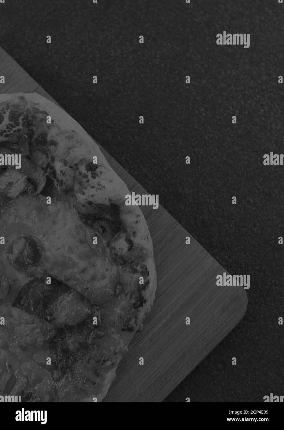Composition of close up of fresh black and white pizza on gray background Stock Photo