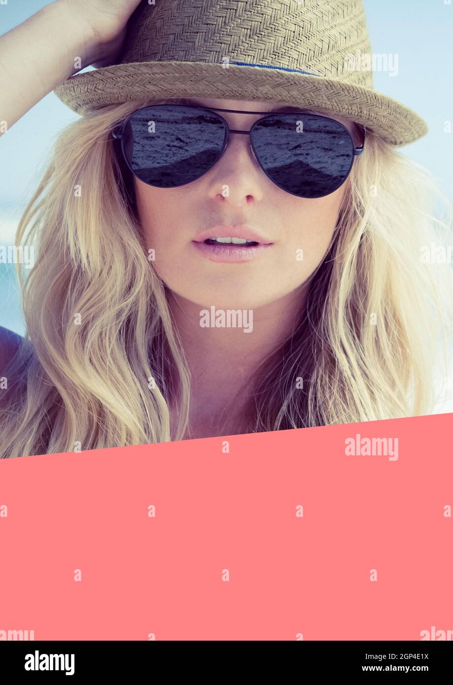 Composition of caucasian woman wearing hat and sunglasses on beach Stock Photo