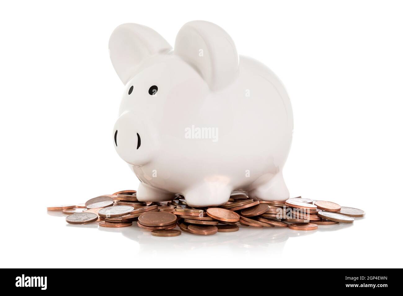 Piggy bank sitting on a pile of coins / saving money concept Stock ...