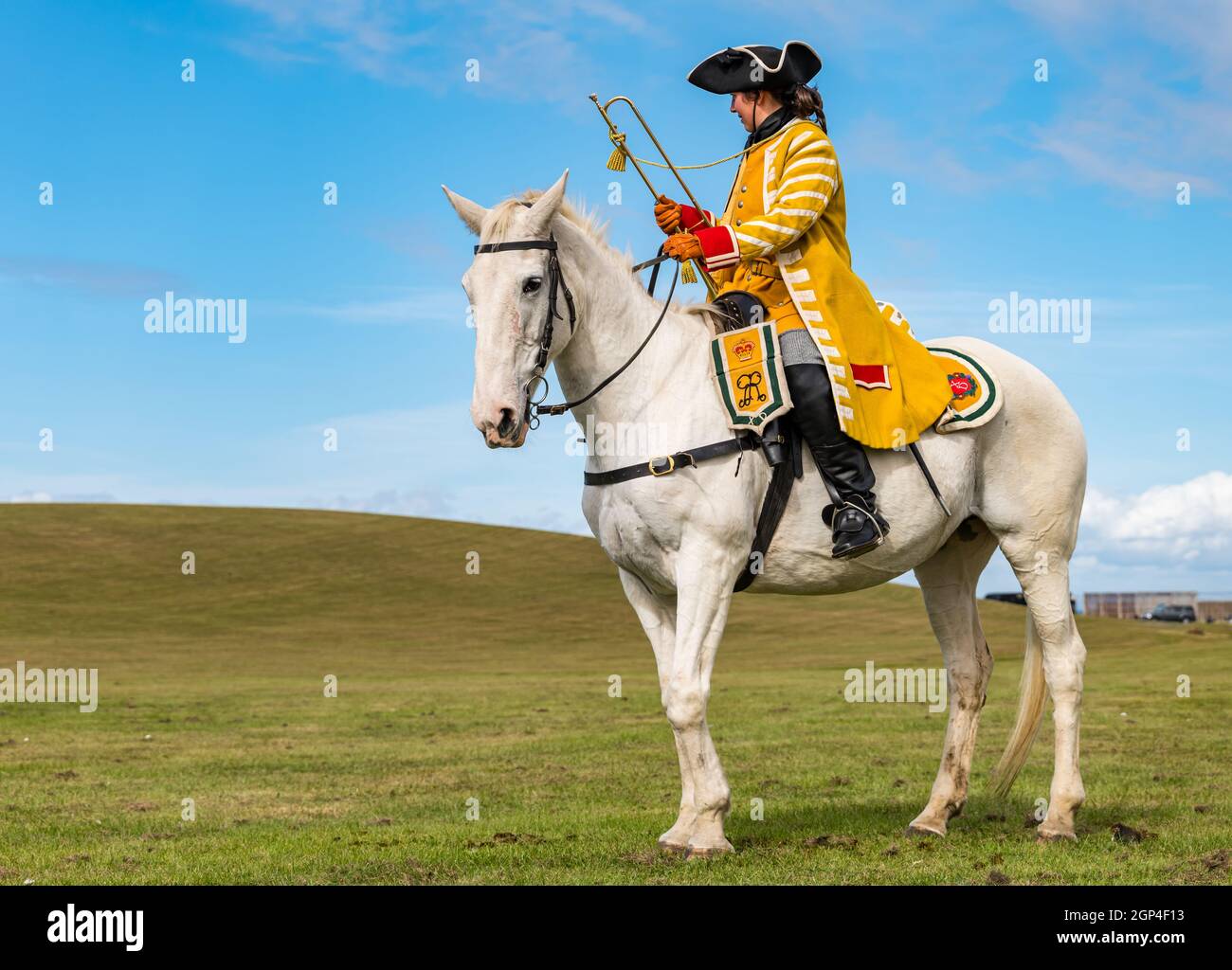 A horse rider with trumpet in re-enactment of Battle of Prestonpans in period costume, East Lothian, Scotland, UK Stock Photo