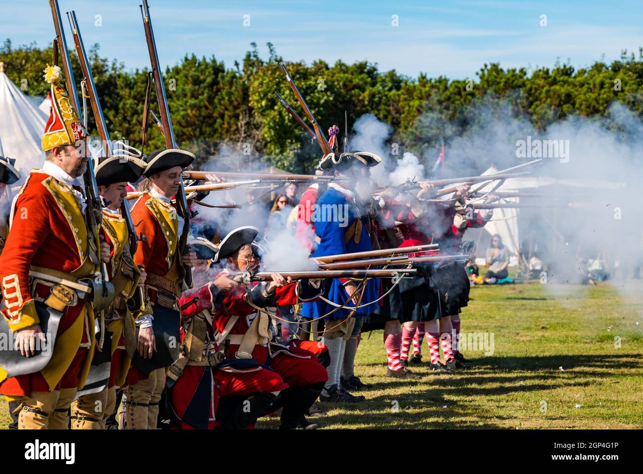 Hanoverian soldiers in period costume fire guns for re-enactment of Battle of Prestonpans , East Lothian, Scotland, UK Stock Photo