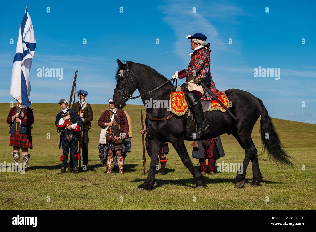 Bonnie Prince Charlie riding a horse and his Jacobite troops in period costume in re-enactment of Battle of Prestonpans , East Lothian, Scotland, UK Stock Photo