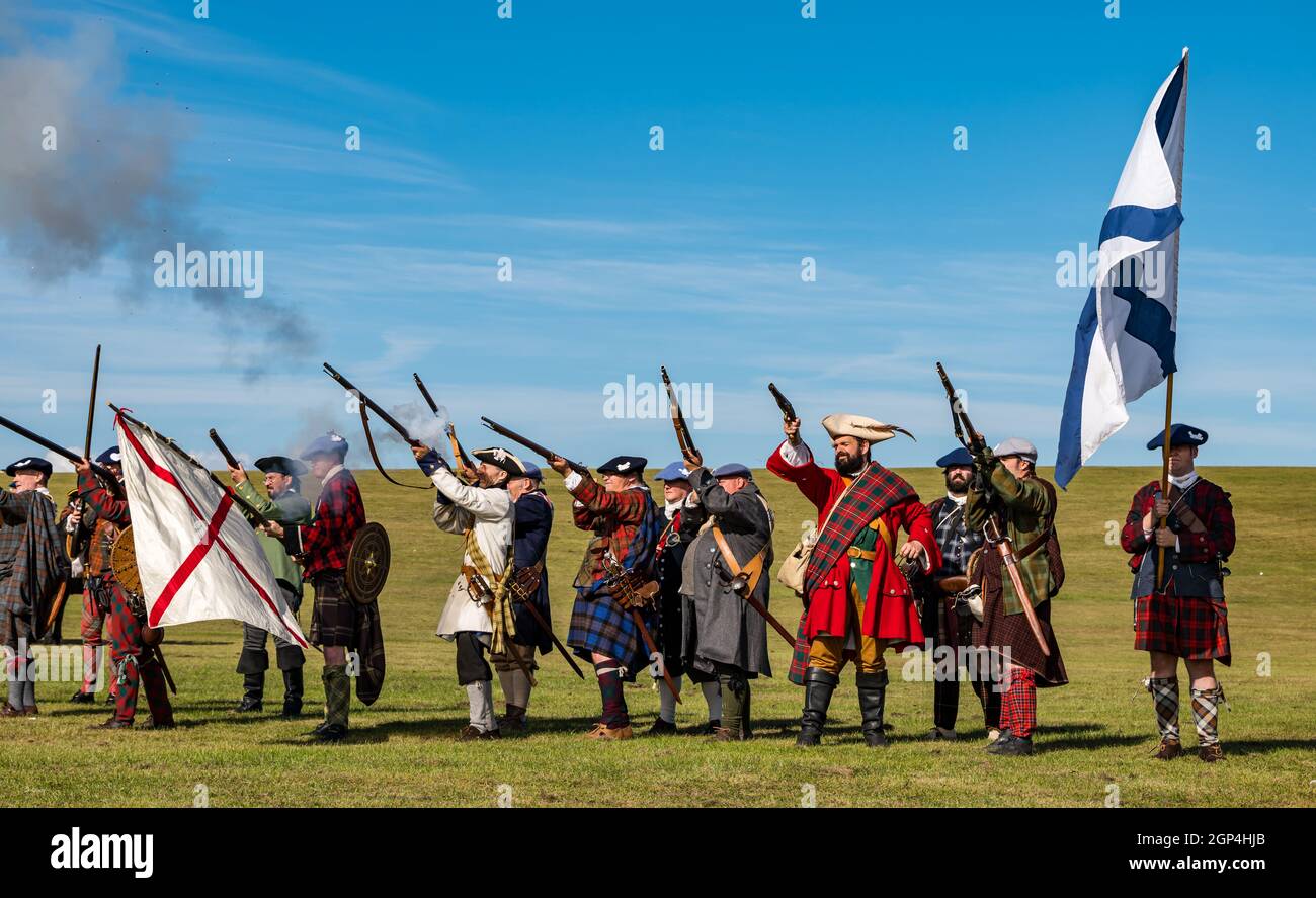 Jacobite Scotsmen in period costume fire guns for re-enactment of Battle of Prestonpans , East Lothian, Scotland, UK Stock Photo