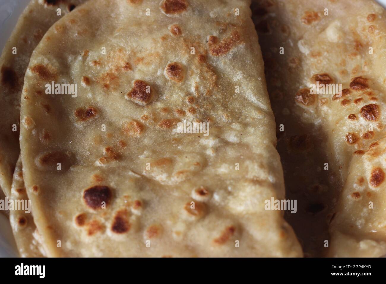 Closeup view of hand made plain bread in oil called paratha roti. Paratha is popular in India