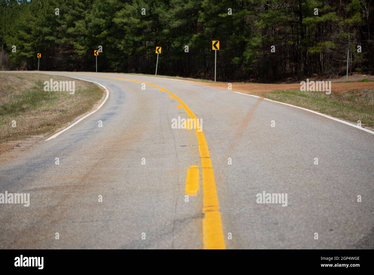 Highway that is about to curve and signs warning of the curve Stock ...