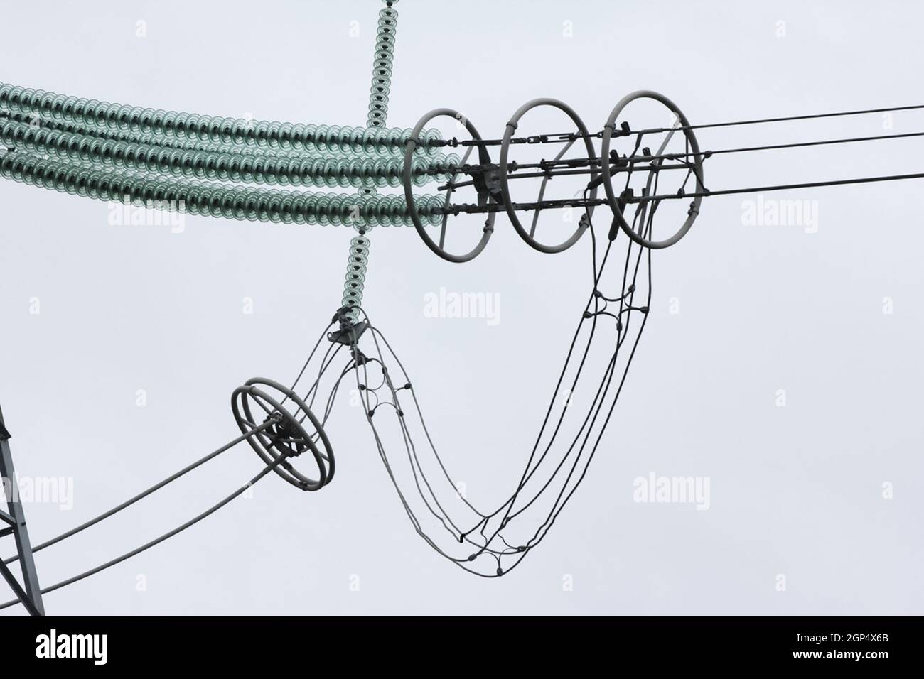 Glass insulators on highvoltage power line poles Stock Photo Alamy