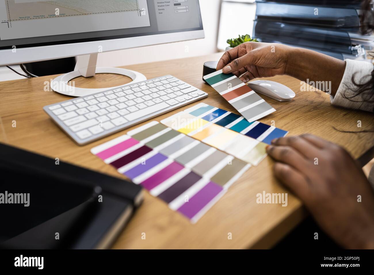 African American Graphic Designer Woman Choosing Coating Sample Stock Photo