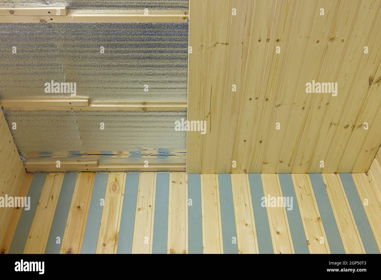 finishing with wooden clapboard ceiling in the room of a country house