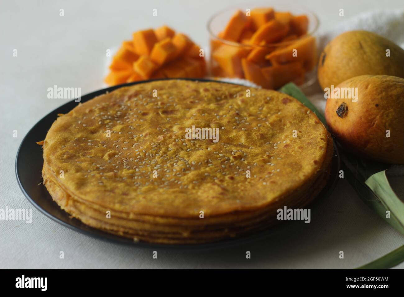 Mango Paratha. Indian flatbread made of wheat flour and mango pulp. A sweet version of Indian flatbread with fresh mangoes topped with sesame seeds. S Stock Photo