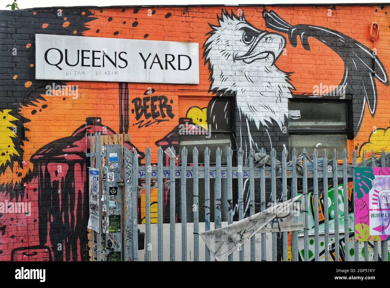 Signage and mural for Queen's Yard in Hackney Wick, East London. Queens Yard is home to breweries and restaurants and holds an annual summer party. Stock Photo