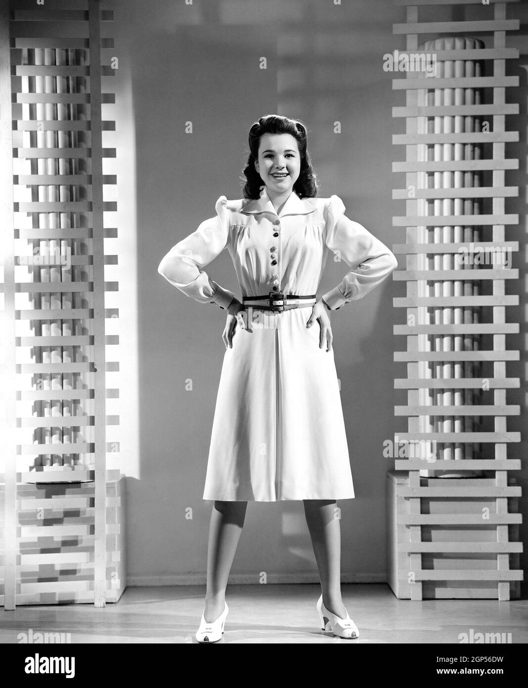 A VERY YOUNG LADY Jane Withers modeling a white wool twill dress