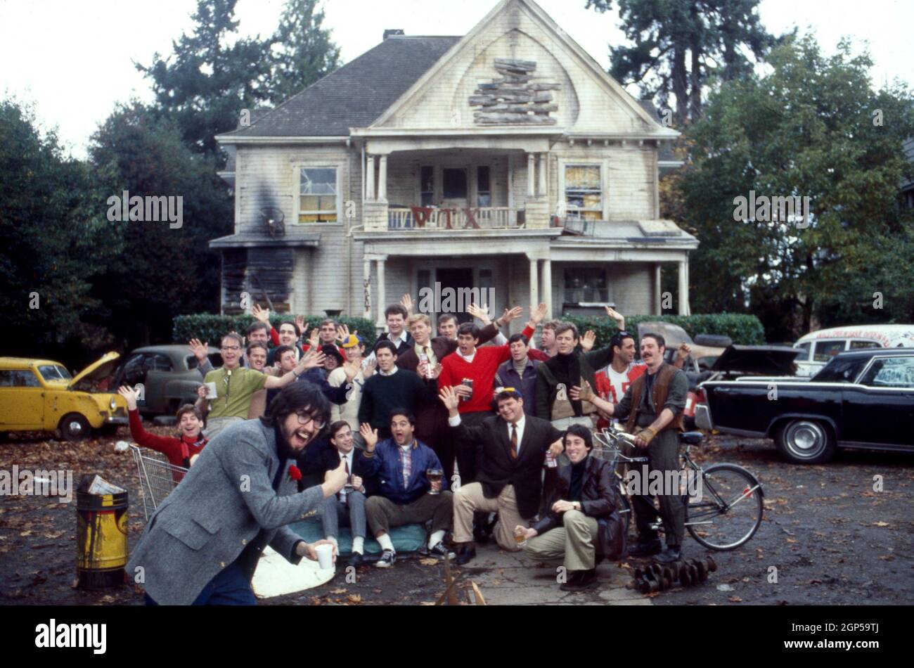 NATIONAL LAMPOON'S ANIMAL HOUSE, director John Landis (foreground left),  producer Ivan Reitman (bottom center) posing in front of the Delta Tau Chi  Frat house with cast members, from left: Joshua Daniel, Douglas