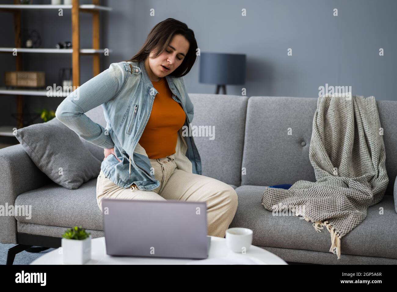 Lower Back Pain. Bad Posture Sitting On Couch Stock Photo Alamy